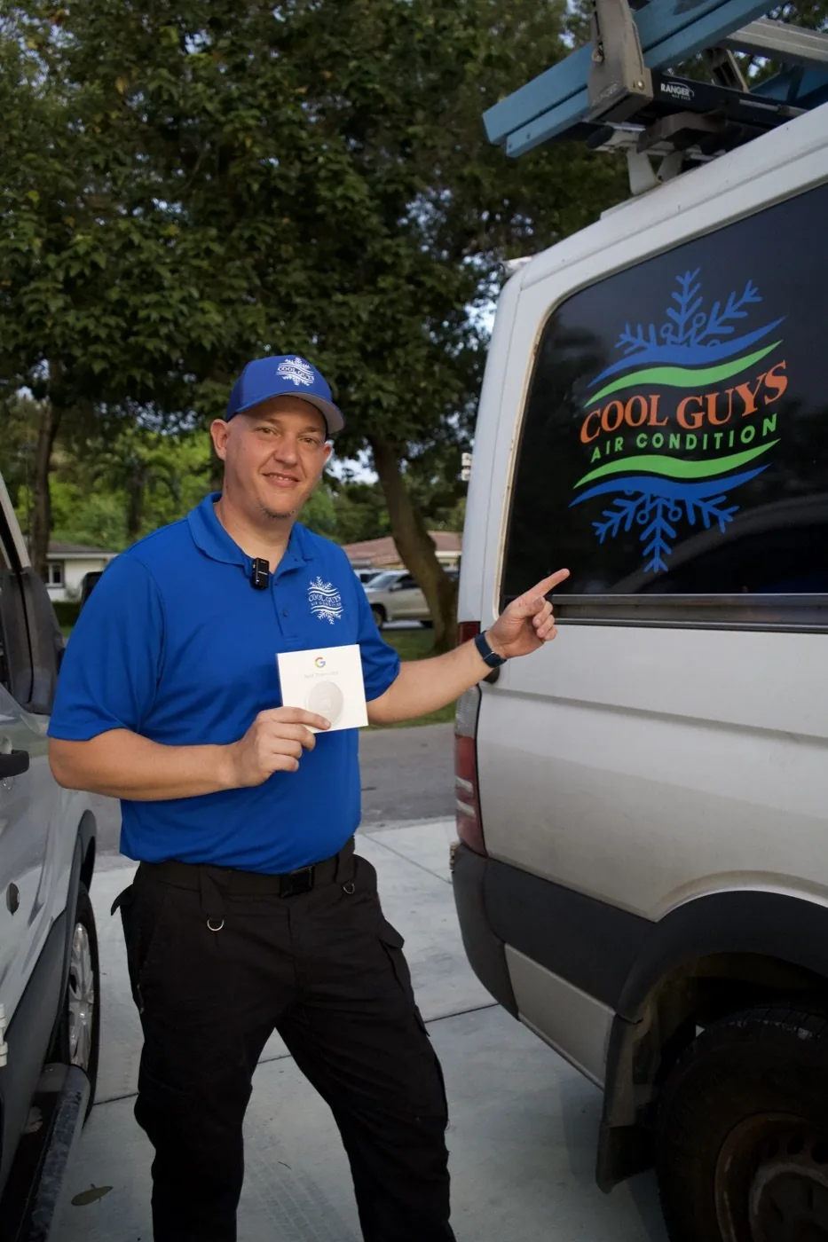 HVAC technician presenting a smart thermostat — marketing photo for a Miami air conditioning company