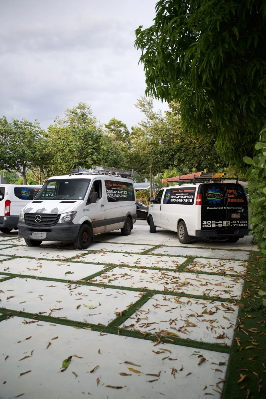 Cool Guys AC fleet trucks with vehicle wraps — contractor brand photography in South Florida